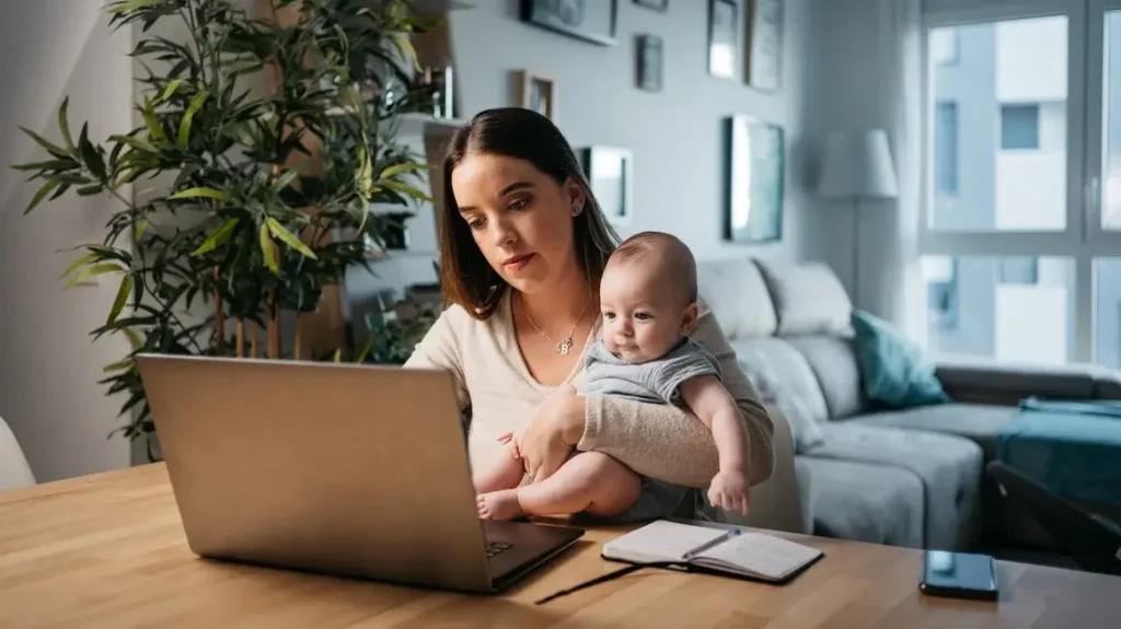 woman holding baby trying to find work life balance (1)